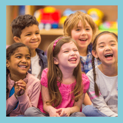 Children smiling and being read to