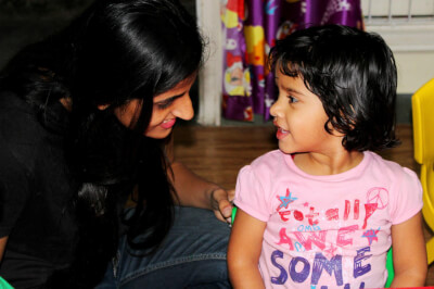 parent and child talking and playing in a school hall